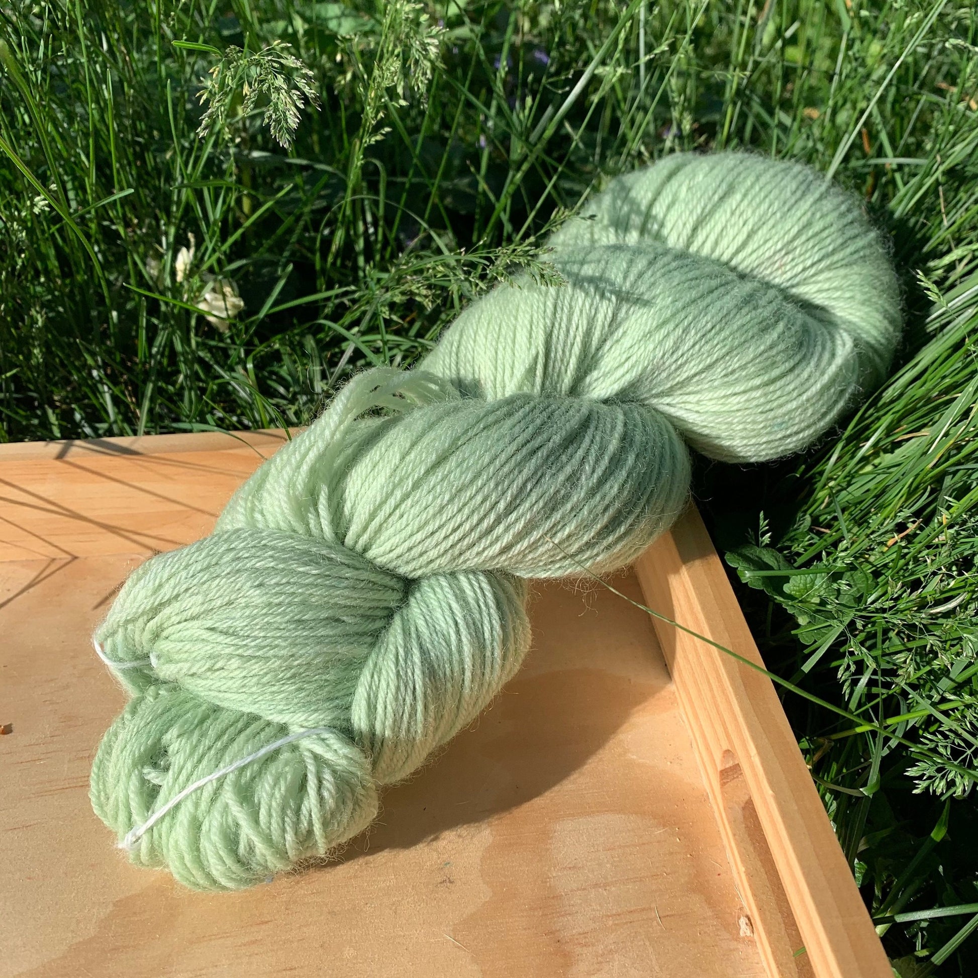 A light green skein of hand dyed yarn.