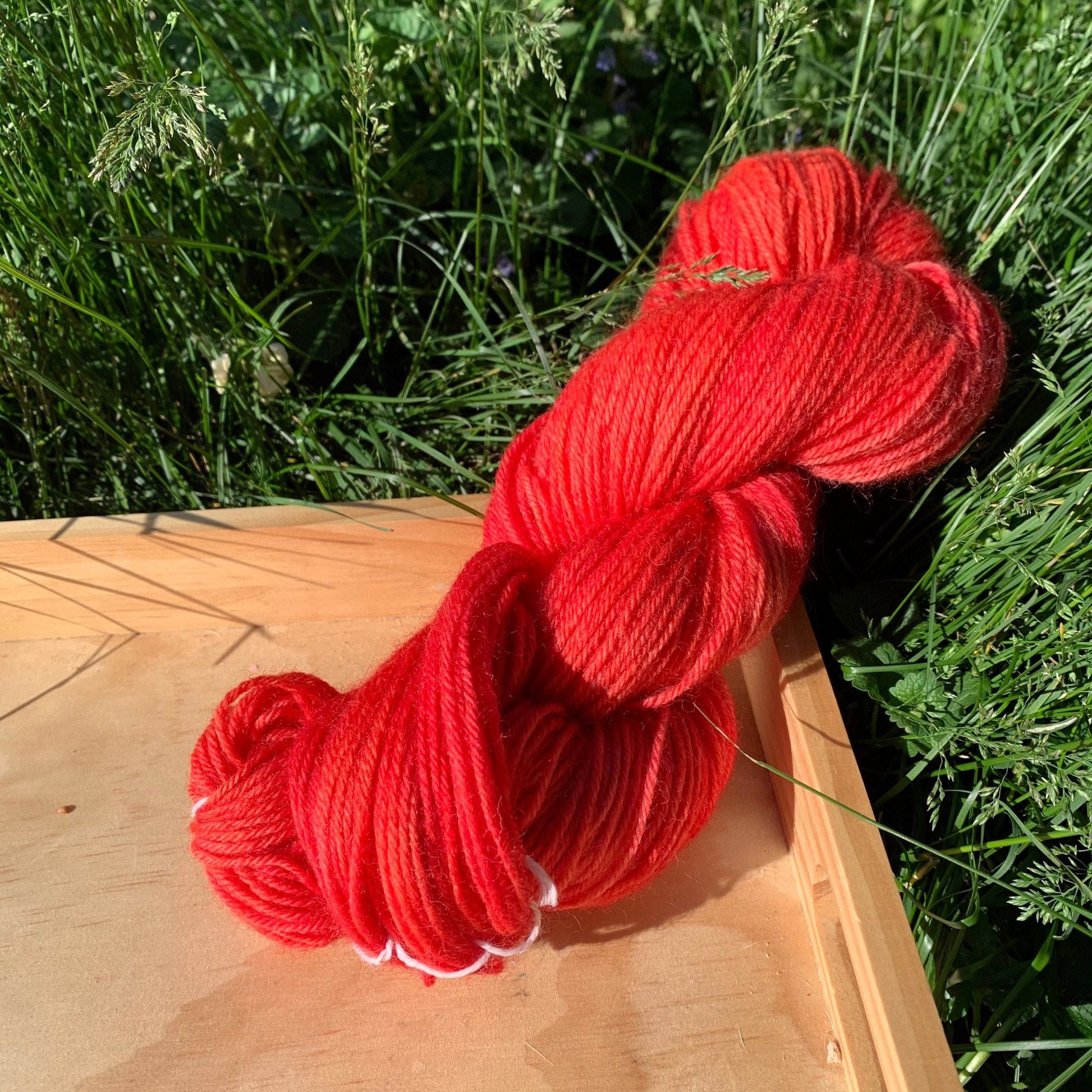 A supersaturated skein of red hand-dyed yarn.