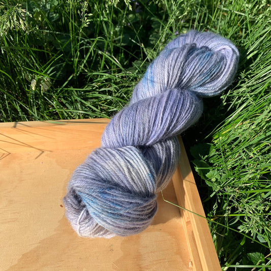 A blue and gray skein of hand-dyed yarn.