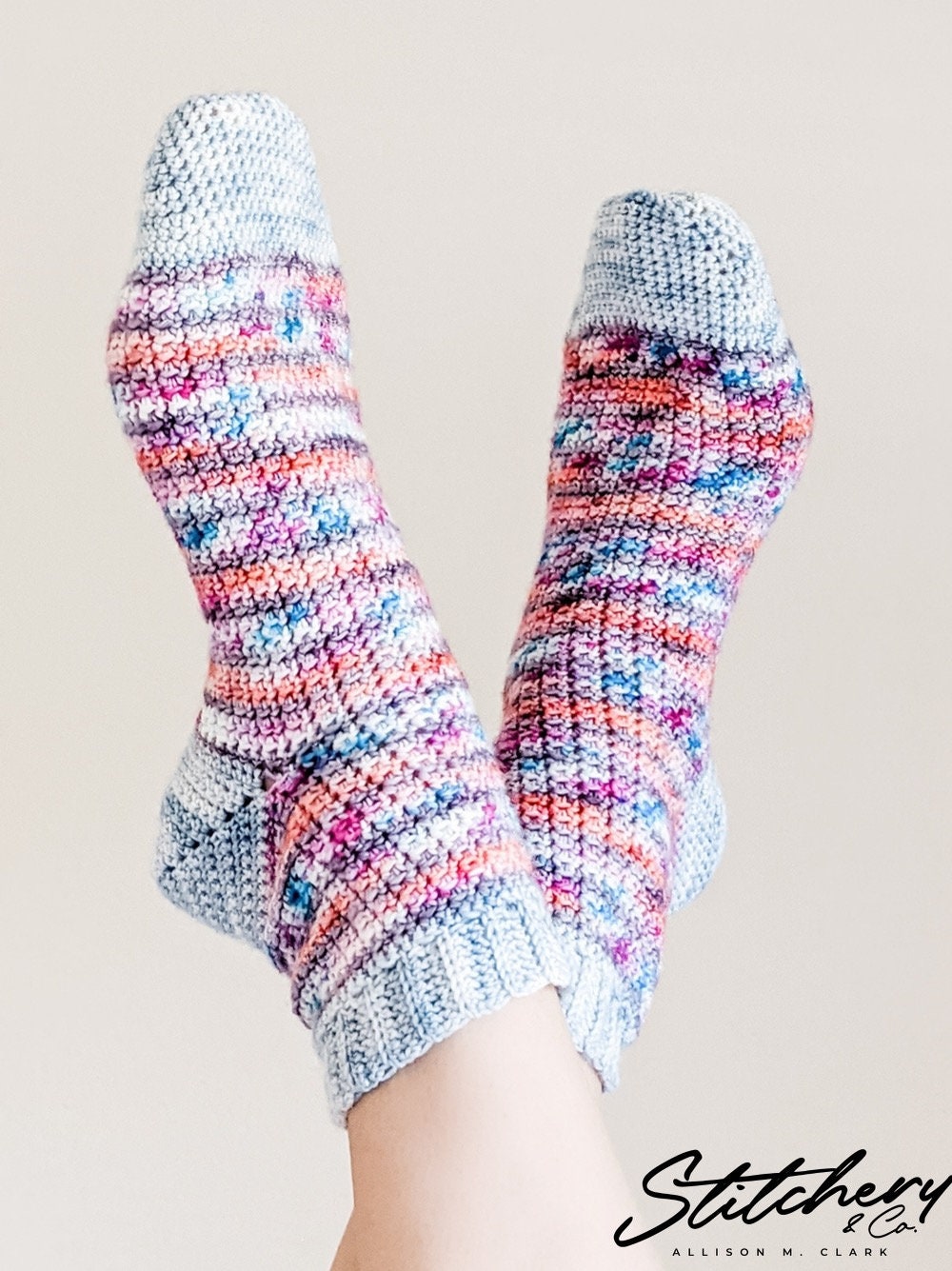 A pair of crochet socks made by Alison at Stitchery and Co out of our Teresina, Blue Ridge, and Edgar Allan Poe colorways.