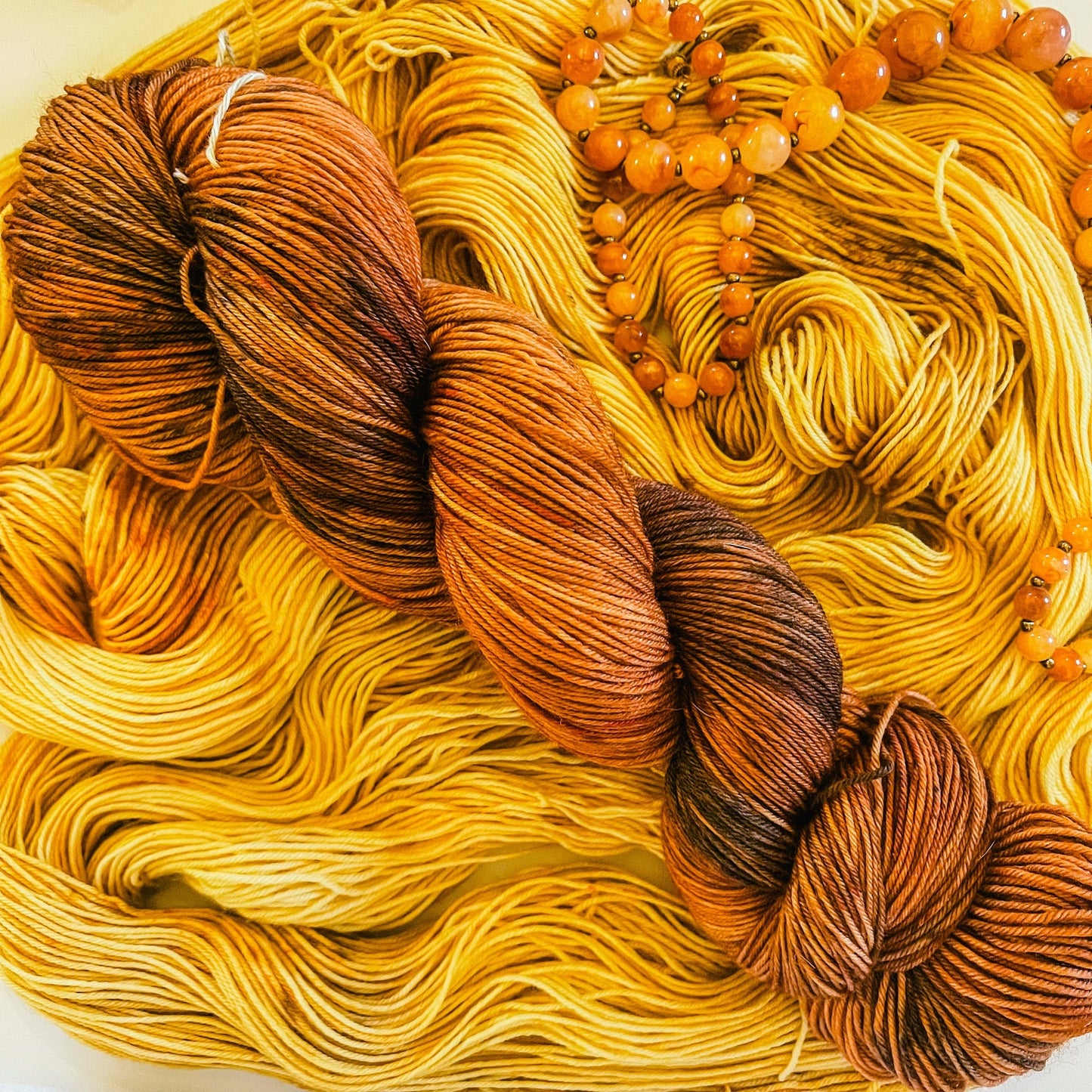 Our Time with its companion black-speckled orange hand-dyed Merino yarn, Chester Copperpot.